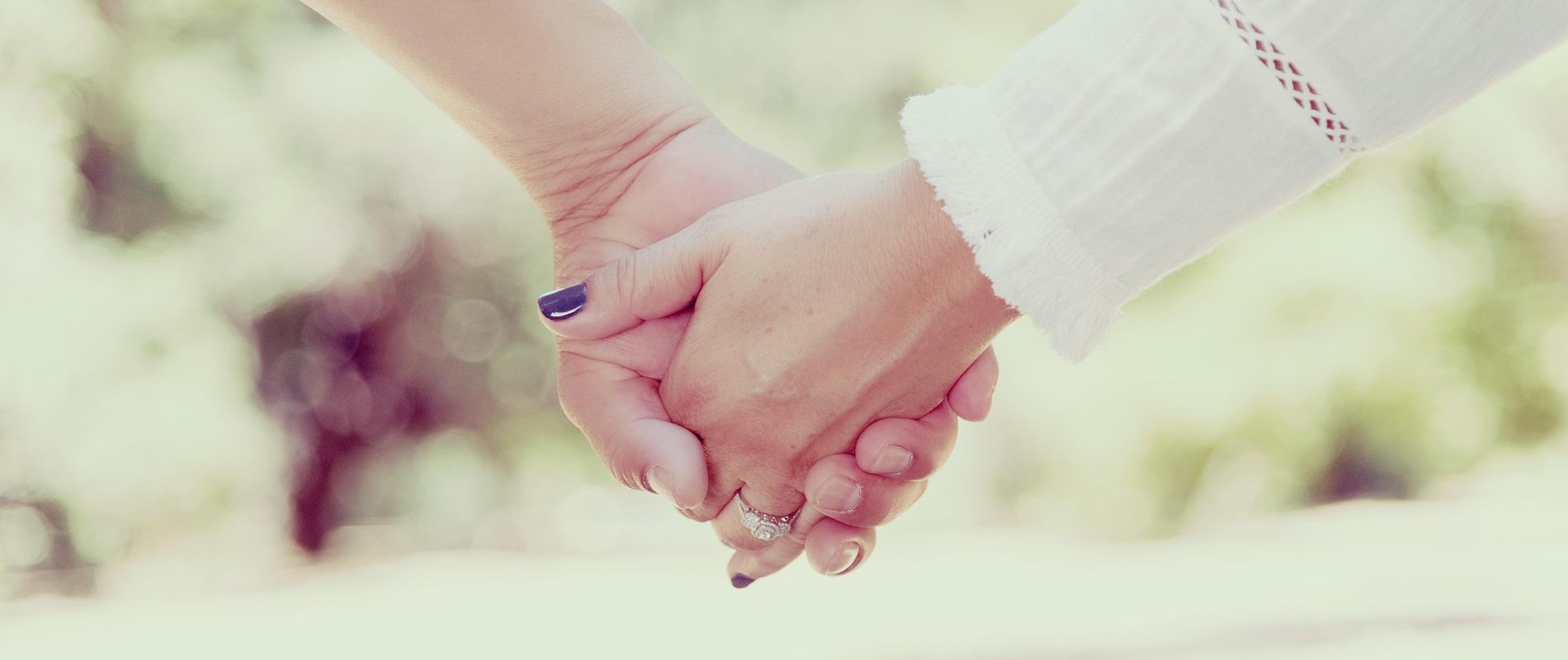Close-up of a couple holding hands, symbolizing emotional connection and renewed intimacy