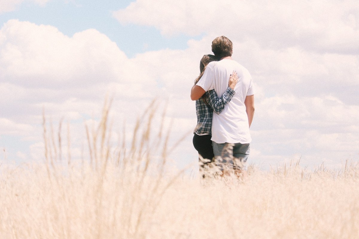Two people hugging as they go through and understand different relationship stages.