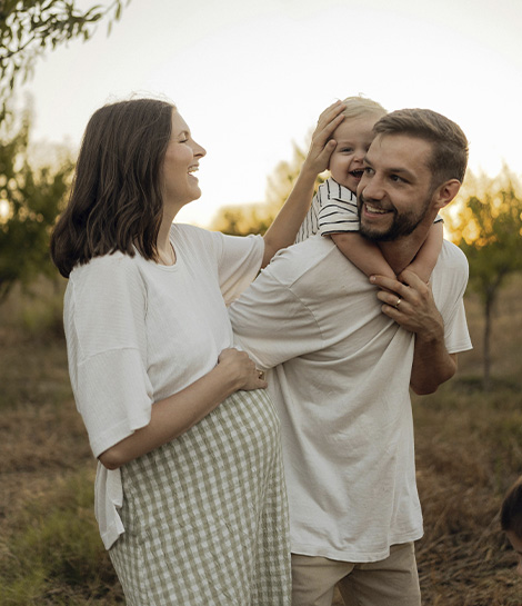 Happy couple with a young child on a walk, represents how your marriage can grow through the support of our Orange County marriage counselors.