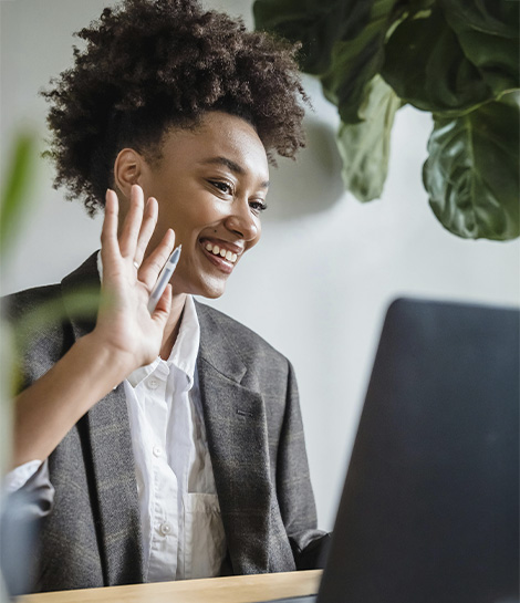 Woman smiling in a video call at work, represents how you can conquer your goals with the support of a ADHD therapist in Orange County.