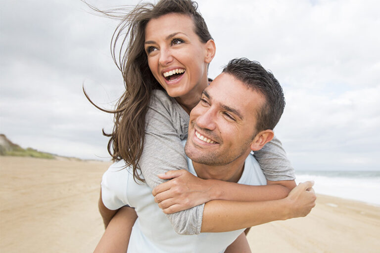 Woman riding on her partner's back, represents how Couples Therapy in Orange County can help your relationship grow.