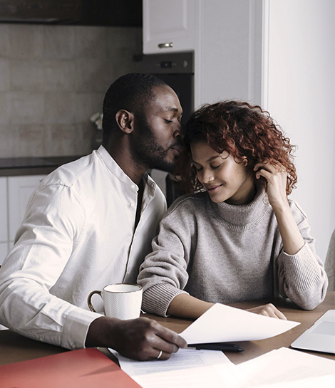 Affectionate couples looking through paperwork together, represents how couples with ADHD can find support in Orange County to overcome their challenges.