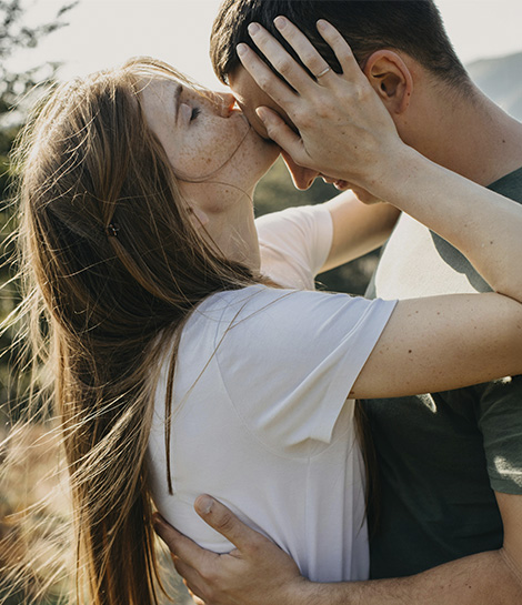 Woman kissing her partner on forehead, represents how discernment counseling in Orange County can guide couples when their relationship may be nearing its end.