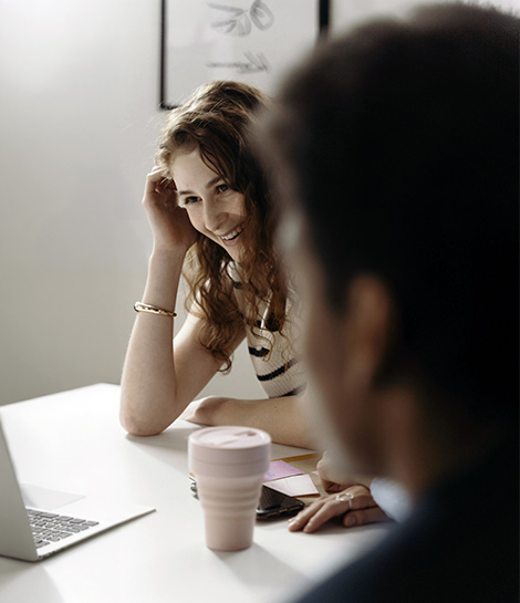 Woman in a work meeting looking a bit uncomfortable, represents how you can find a social anxiety therapist to support you.