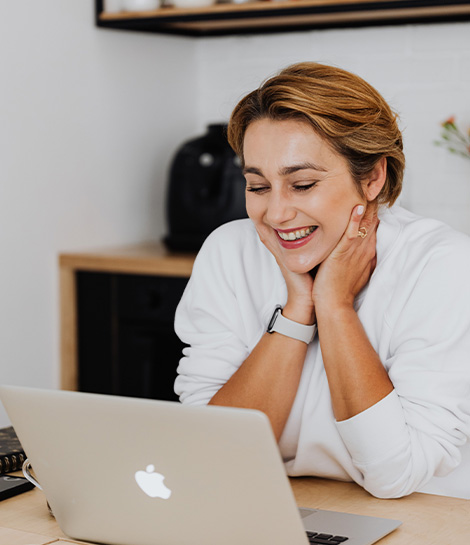 Woman smiling during a virtual therapy session, represents how