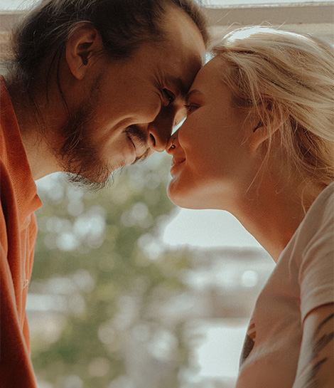 Couple shares a romantic, intimate moment, represents how the Gottman method is effective to help couples through relationship issues.