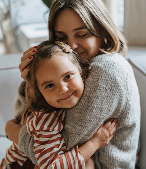 Mother holding her young daughter, represents how TF CBT can help you heal from childhood trauma and past experiences.